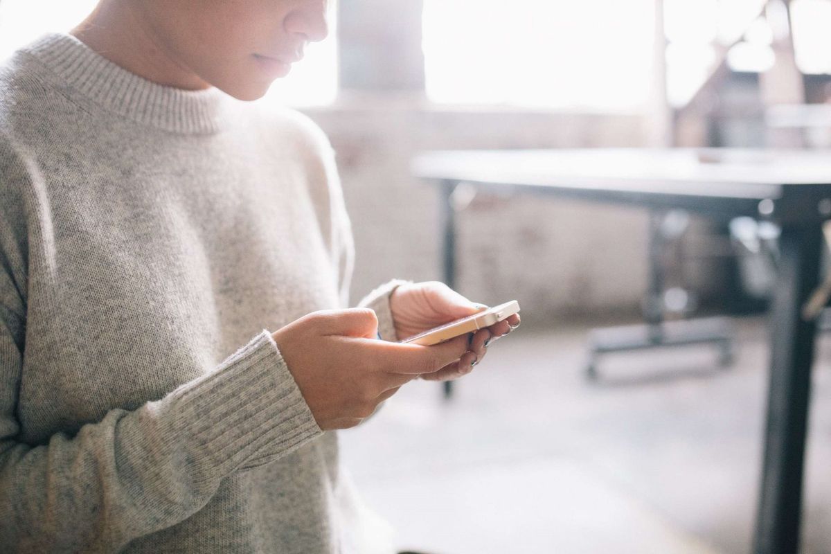 Person holding cell phone scheduling something